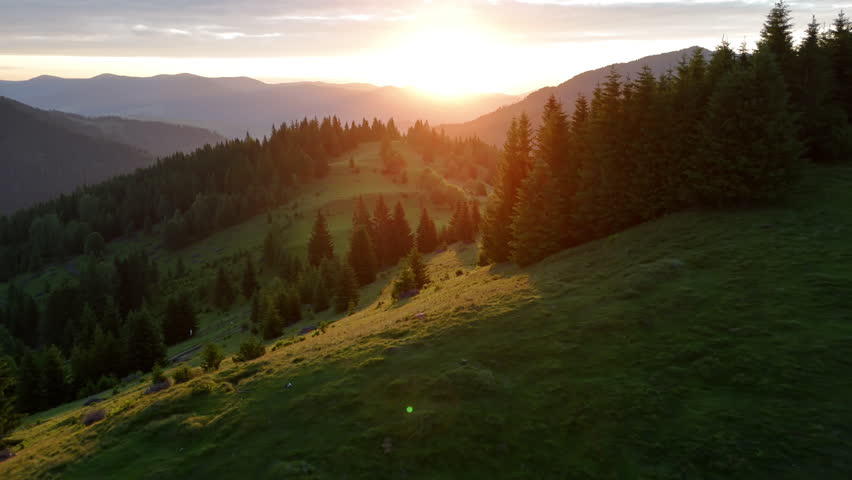Sunrise Over Carpathian Valley with Wooden Huts, Light Breaking Through Forested Hills and Morning Mist