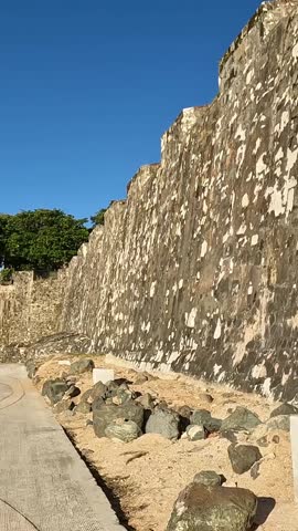 walking along path with view of fort in old san juan puerto rico (abandoned old spanish fortification colonial structure) lookout tower along the caribbean sea coast 