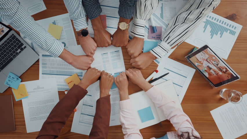 Documents, finance and fists business people in circle for collaboration or unity from above. Accounting, paperwork and solidarity with hands of employee team in workplace together for support