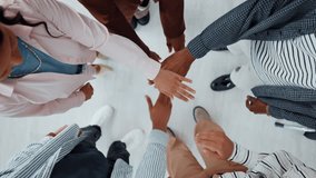 Hands stacked, business people and teamwork in office for unity, solidarity and motivation. Men, women and collaboration for goal, success and celebration from above staff with applause for win - Powered by Shutterstock - Get 15% off with code: PIKWIZARD15