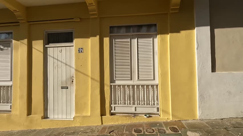 walking in old san juan puerto rico passing historic old colorful spanish colonial buildings in downtown caribbean travel tourism destination scenic houses homes street holiday getaway sunshine
