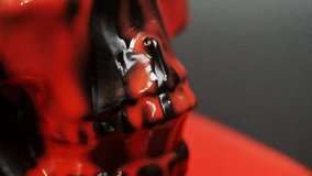A black human skull in close-up view, with vivid red liquid slowly dripping over its surface. The contrast between the dark matte skull and the glossy red fluid creates a dramatic and intense visual. - Powered by Shutterstock - Get 15% off with code: PIKWIZARD15