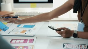 Female UXUI professional designing mobile app interface, sketching on paper and smartphone, strategizing user centered digital solution for innovative application development - Powered by Shutterstock - Get 15% off with code: PIKWIZARD15