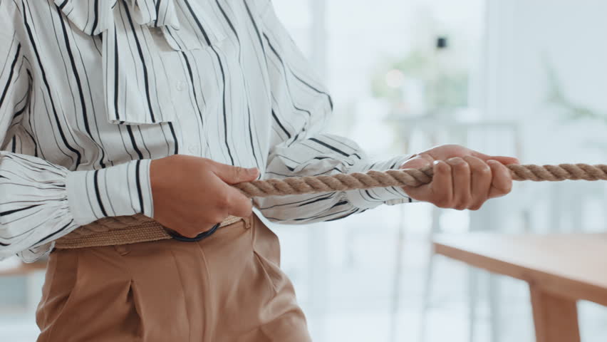 Tug of war, hands and woman with competition, game and battle challenge in business office. Teamwork, cooperation and person pull rope with strength, power and collaboration for contest or fight