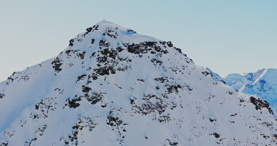 Ski mountaineers atop Bec des Rosses, Val de Bagnes, with Grand Combin behind, ready to drop into the legendary north face.