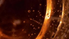 Golden bubbles swirl and rise inside a glass of sparkling wine. Abstract macro view highlighting effervescent texture and rich color. - Powered by Shutterstock - Get 15% off with code: PIKWIZARD15