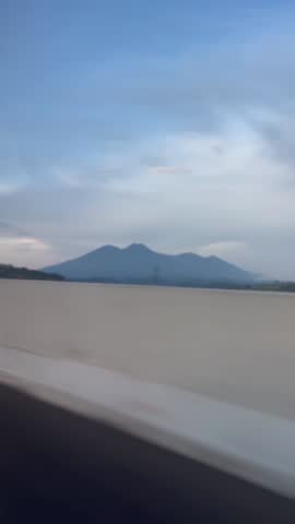 slow motion
mountain view on the side of the highway, clearly visible even though it was taken in a moving car.