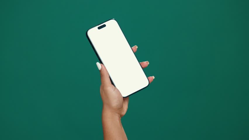 Person, hands and phone screen with mockup space in studio for advertising or marketing. User, model or showcase with mobile smartphone for new app, social media platform or UI on a green background