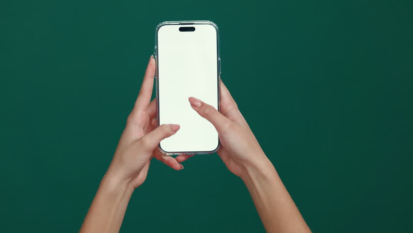 User, hands or phone screen with space in studio for advertising or UX on a green background. Person, model or display with mobile smartphone mockup for new app, social media platform or UI marketing