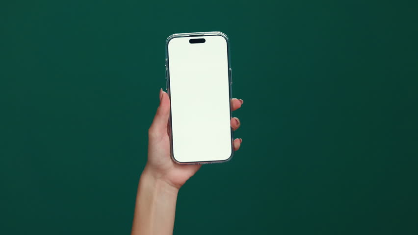 User, hands or phone screen with mockup space in studio for advertising or UX on a green background. Person, model or display with mobile smartphone for new app, social media platform or UI marketing