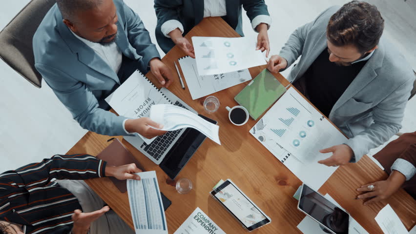 Above, finance and business people in meeting, charts and accounting with feedback for budget report. Group, documents or employees in office, collaboration and graphs for inflation or data analytics - Powered by Shutterstock - Get 15% off with code: PIKWIZARD15