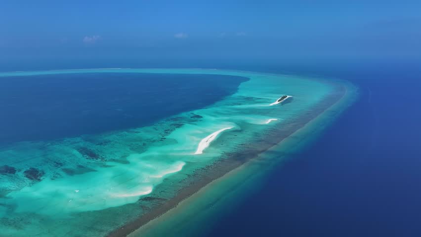 Aerial view of the stunning turquoise waters surrounding a sandbank at Fulhadhoo, with the deep blue ocean contrasting the shallow reef, Fulhadhoo, Baa Atoll, Maldives.