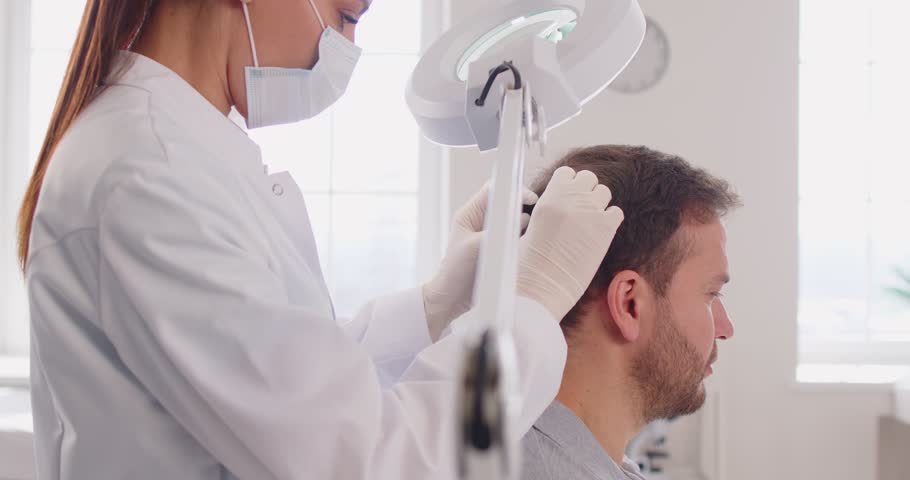 Trichology study of hair and scalp, medical practitioner, dermatologist making male head hair diagnosis and treatment for pediculosis or hair loss, head lice infestation, trichologist clinic treating