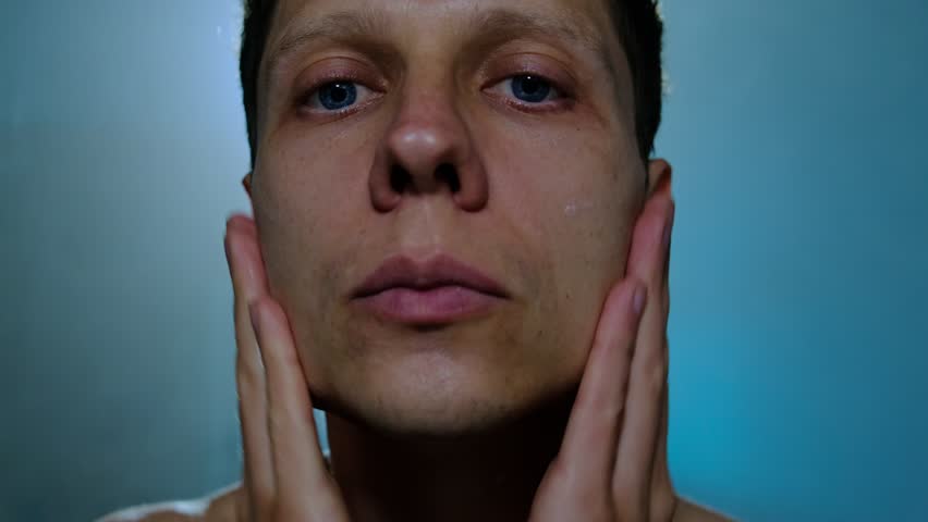 Routine for men. Man applying aftershave cream