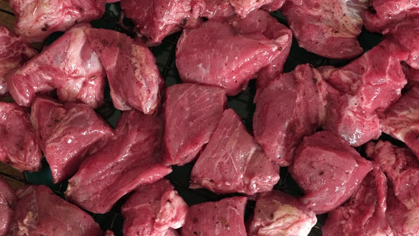 Raw sliced pork in sauce. Pieces of fresh marinated pork medallions. Freshly meat tenderloin, perfect for culinary, home cooked meals and flavor. Chopped Pork ham fillet with spice, herbs. 4K video