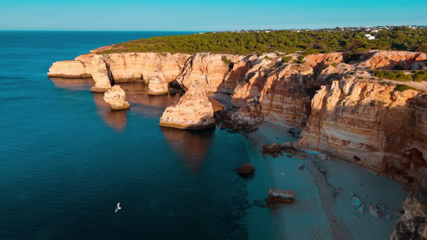 This aerial view captures the remarkable cliffs and serene waters of Portugal