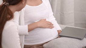 Healthcare for pregnancy, Asian Lesbian couple enjoying a heartfelt moment while gently touching the pregnant belly, expressing joy, care, and anticipation of parenthood in a modern loving family - Powered by Shutterstock - Get 15% off with code: PIKWIZARD15