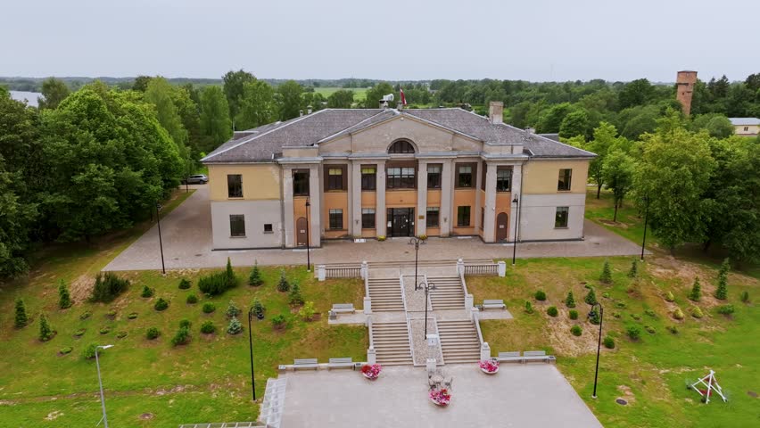 Aerial of Brocēni Cultural Center with classic facade, surrounding park Latvia