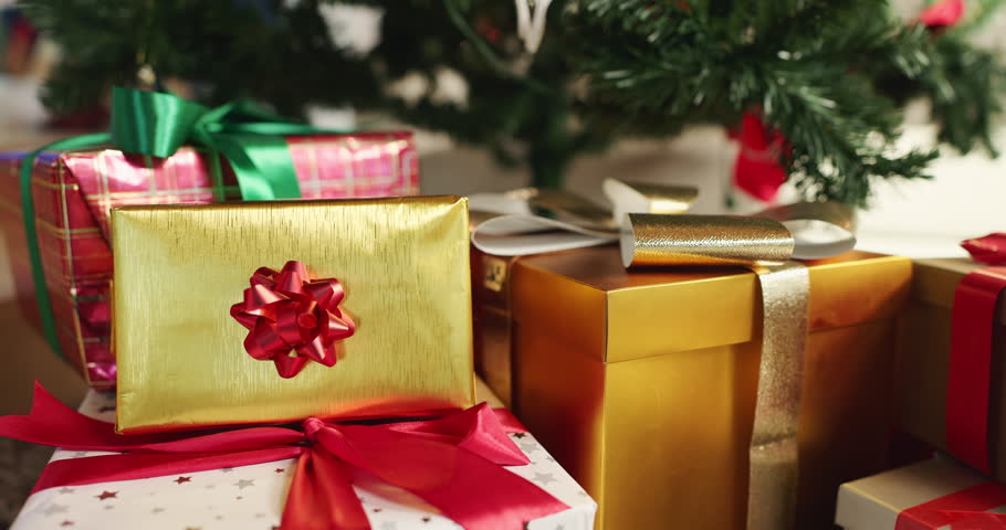 Christmas, tree and gifts with boxes or ribbon for festive or december holiday celebration in home. Closeup, decorations or presents with surprise for new year, santa or christian tradition in house