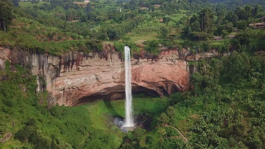 Aerial view of Sipi Falls cascading from rugged cliffs into dense vegetation on the slopes of Mount Elgon near Kapchorwa, showcasing the region's iconic geology and tropical environment