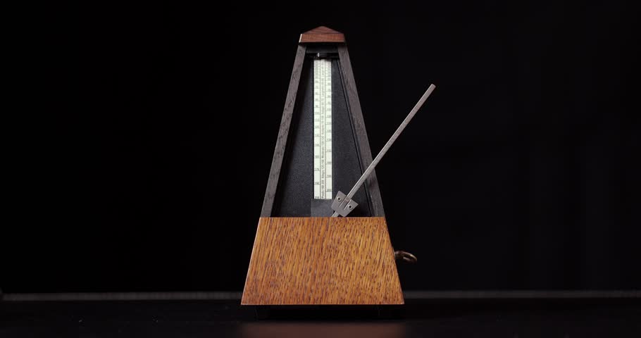 Classic metronome clicking, ticking, black background, loopable video, marking regular intervals, fast tempo
