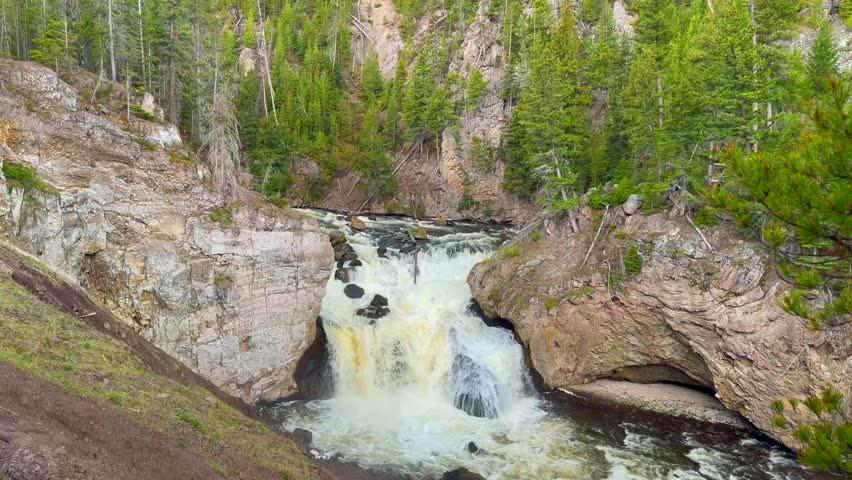 Scenic landscape view of the Firehole Falls in a gorge on the Firehole River in Yellowstone National Park
