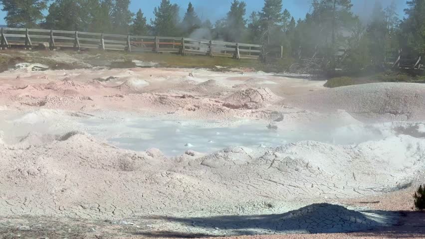 Bubbling mud pot pool of hot mud on the Fountain Paint Pot Trail in the Lower Geyser Basin in Yellowstone National Park. 