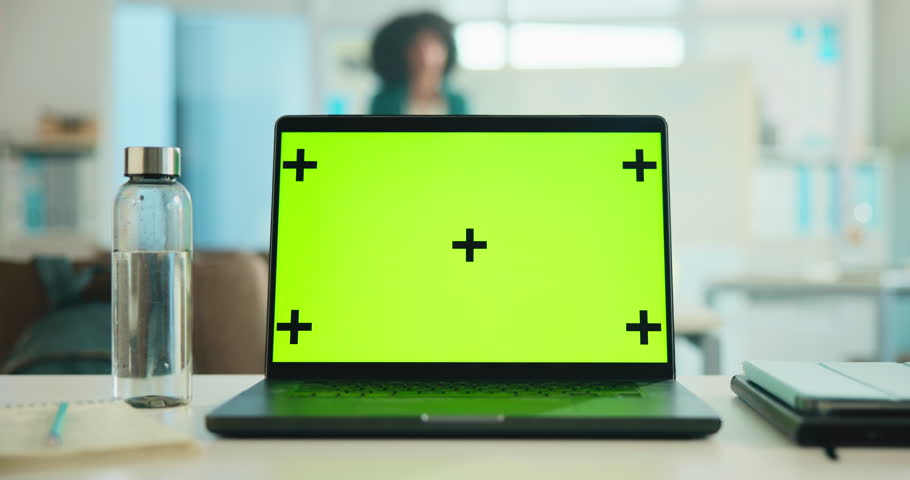 Laptop, green screen and mockup in office for marketing website on desk with tracking markers. Computer, workspace and display for advertising, business and monitor for software design on internet