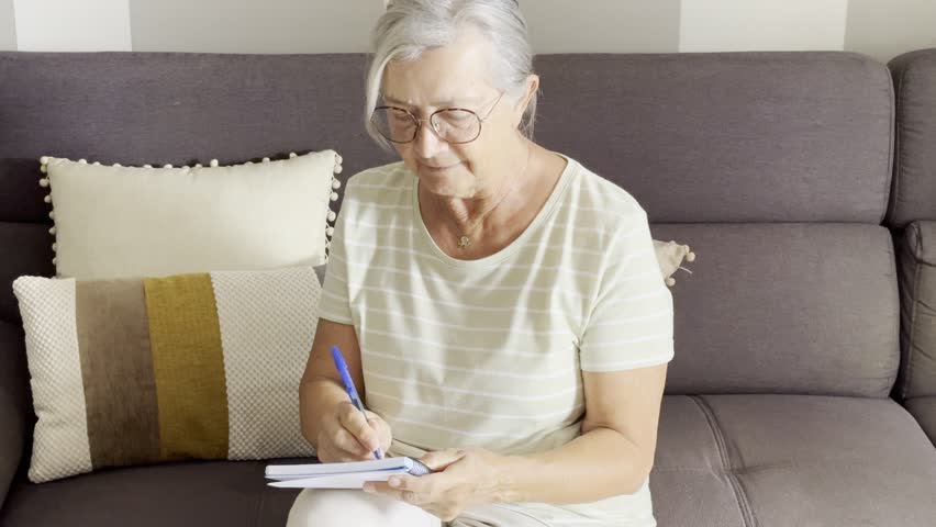 Elderly woman at home engaging in various daily activities alone. A calm and authentic depiction of senior life, independence, aging with grace, and the simple beauty of everyday moments indoors