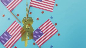 After gentle nudge gold home keychain swinging and rotating in shimmering light showing patriotism. Patriotism, celebration, independence, luxury, reflection, craftsmanship, festive - Powered by Shutterstock - Get 15% off with code: PIKWIZARD15