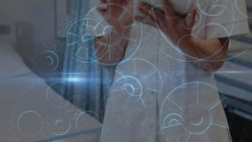 Female doctor tapping tablet and swiping data for processing while holographic cogs rotate fading. Healthcare, technology, innovation, telemedicine, data, digital, professional - Powered by Shutterstock - Get 15% off with code: PIKWIZARD15