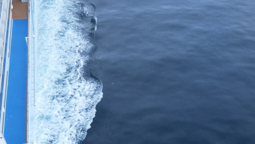 view to the waves rippling on water surface on side of passenger cruise ship while cruising in the ocea sea in daytime, wirling water while cruising, wave on sea water surface background