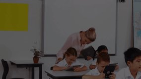 Lesson starting with map overlay pulsing in classroom as teacher guiding students tapping tablets. Education, technology, e-learning, classroom, digital, training, innovation - Powered by Shutterstock - Get 15% off with code: PIKWIZARD15