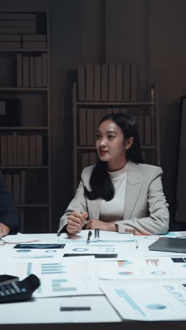 Confident businesswoman sealing partnership deal, shaking hands with colleagues after successful night meeting, celebrating shared professional achievement in modern office setting