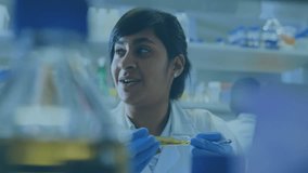Lab researcher holding test tube examining sample generating red blue charts showing percentages. Scientist, laboratory, data, analytics, research, scientific, precision - Powered by Shutterstock - Get 15% off with code: PIKWIZARD15
