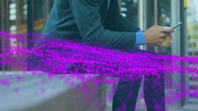 Man scrolling phone on bench outside glass building driving purple particle wave showing technology. Technology, digital, innovation, networking, modern, connectivity, futurism - Powered by Shutterstock - Get 15% off with code: PIKWIZARD15