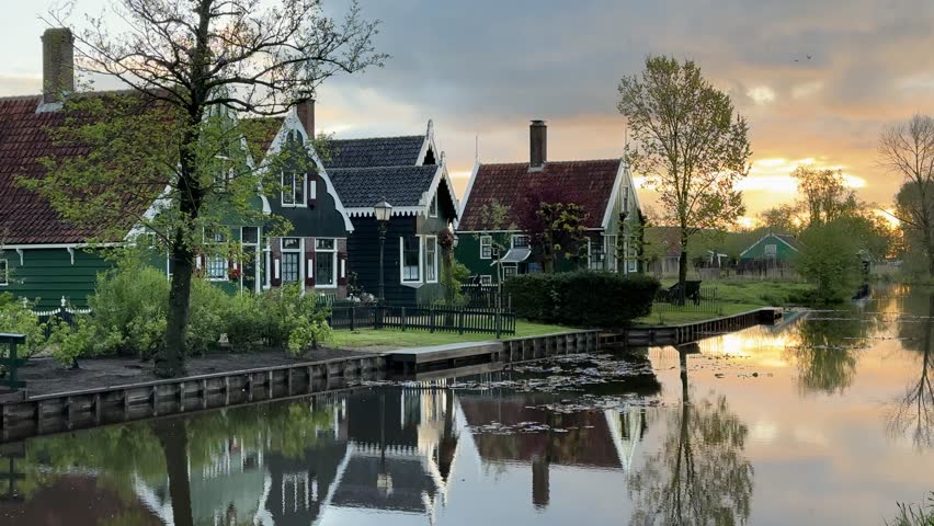 traditional Dutch small town scenery in Zaanse Schans over water at summer sunset, Netherlands