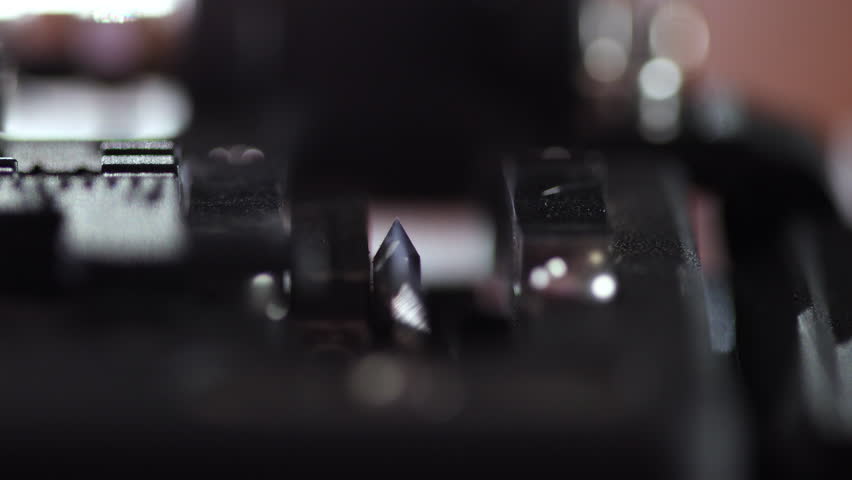 Macro shot of fiber core being inserted and precisely cleaved inside a fiber cleaver