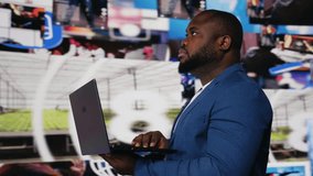 African american man on laptop immersed in a world of online content, representing the future of social interaction, AI driven platforms and modern digital experiences. User interface. Camera B. - Powered by Shutterstock - Get 15% off with code: PIKWIZARD15