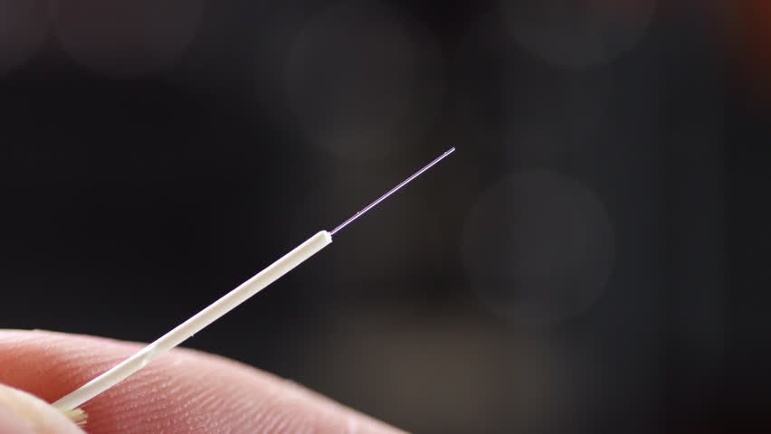 Close-up of a cleaned and cleaved optical fiber, ready for connector insertion