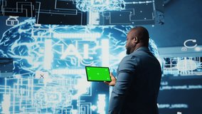 African american engineer shows tablet with isolated mockup display, examining predictive analytics and neural networks for data processing automation and innovation. Cybernetics. Camera A. - Powered by Shutterstock - Get 15% off with code: PIKWIZARD15