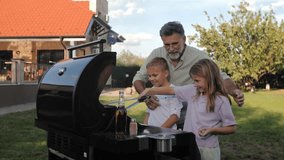 Elderly grandfather sharing grilling techniques with grandkids, passing down culinary skills during relaxed backyard family moment - Powered by Shutterstock - Get 15% off with code: PIKWIZARD15