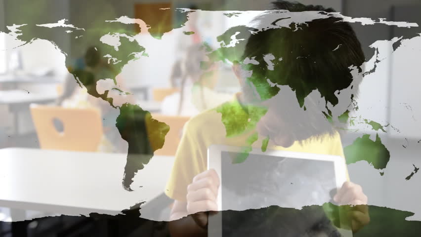 Schoolboy raising tablet and tilting as map overlay fading out in class to share education content. Education, technology, innovation, learning, classroom, youth, digital