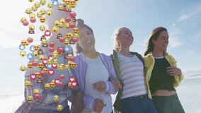 Four women linking arms stepping on beach, launching social media reaction icons engaging viewers. Friends, unity, celebration, outdoor, vibrant, joy, connectivity - Powered by Shutterstock - Get 15% off with code: PIKWIZARD15