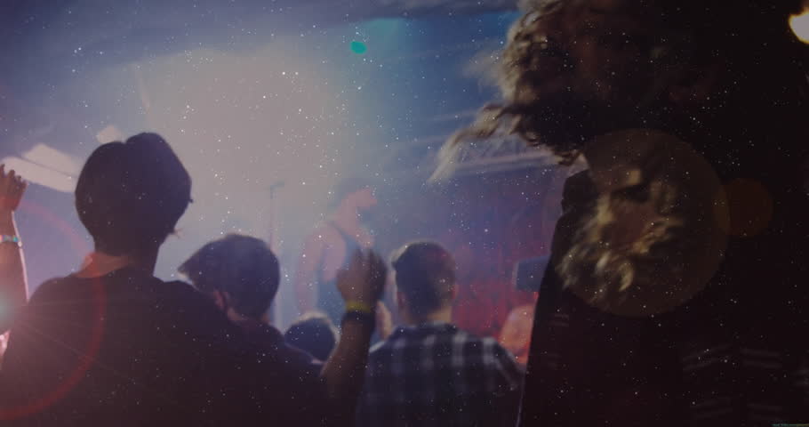 music concert kicking off sparking dreadlocked man headbanging while friend raising arms under haze. Live music, dance, nightlife, vibrant, energetic, stage, crowd