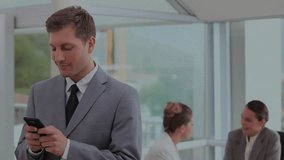 Businessman reading smartphone in business lounge rotating globe glowing nodes and placing call. Professional, networking, digital, corporate, modern, communication, collaboration - Powered by Shutterstock - Get 15% off with code: PIKWIZARD15