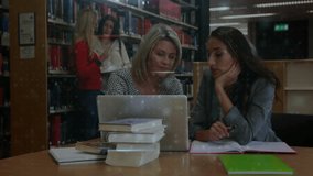 Third student walking through library sparking data grid while students analyzing laptop data. Collaboration, research, data visualization, educational, digital, academic, technology - Powered by Shutterstock - Get 15% off with code: PIKWIZARD15