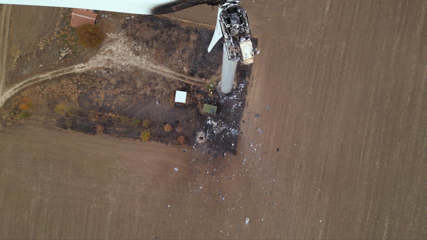 Close up footage of a burned down wind turbine generator. Lightning strike of windmill or overheating caused meltdown of power generator engine and mechanical system. Destroyed infrastructure Disaster