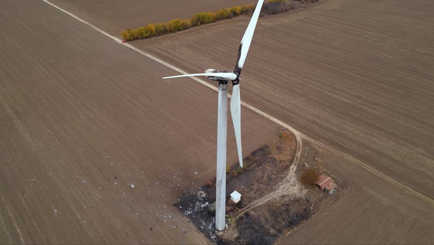 Close up footage of a burned down wind turbine generator. Lightning strike of windmill or overheating caused meltdown of power generator engine and mechanical system. Destroyed infrastructure Disaster