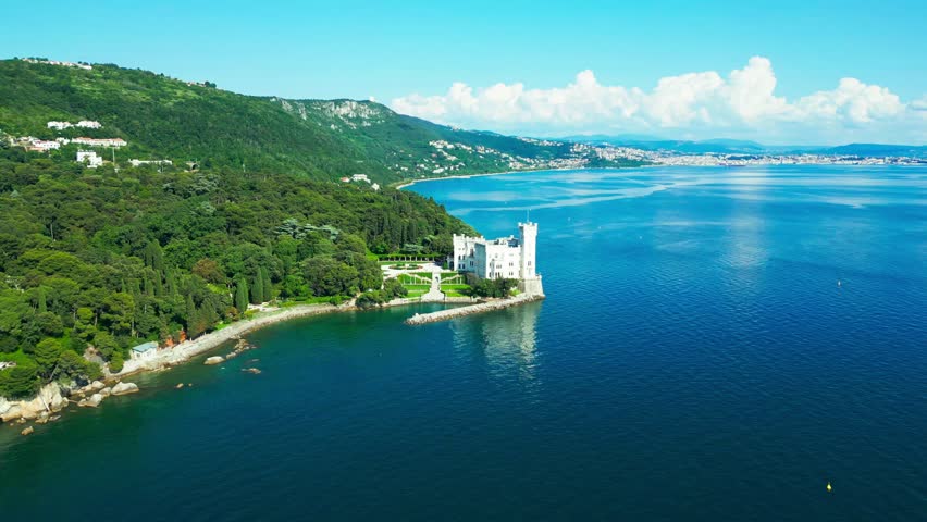 Overlooking the Gulf of Trieste, Miramare Castle rises from the rocky coastline, framed by emerald forest and endless blue sea—an iconic vision of elegance on Italy’s northeastern shores.